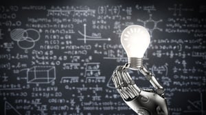 robot hand holding up a light bulb in front of a chalk board full of formulas